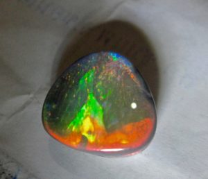  opal gemstone with multi- colours mixed into 1 opal.