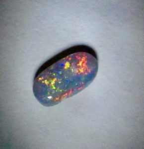  opal gemstone multi- colours mixed with red also.