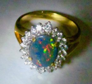 ring with opal gemstone multi- colours mixed.